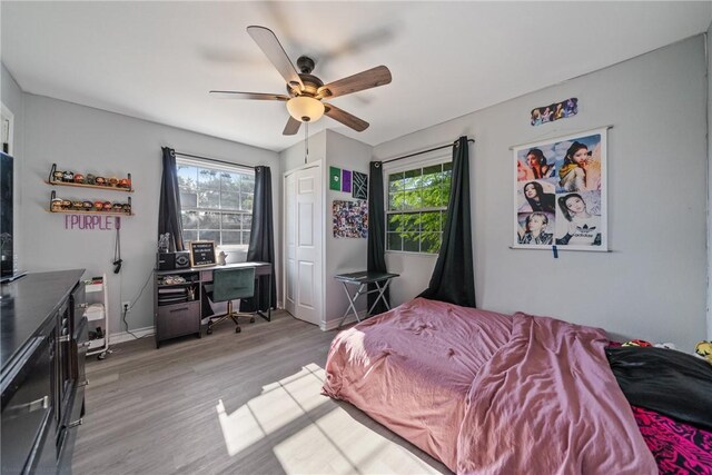 bedroom with ceiling fan and light hardwood / wood-style flooring