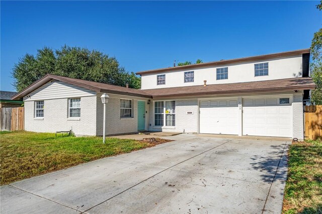 view of property with a garage and a front yard