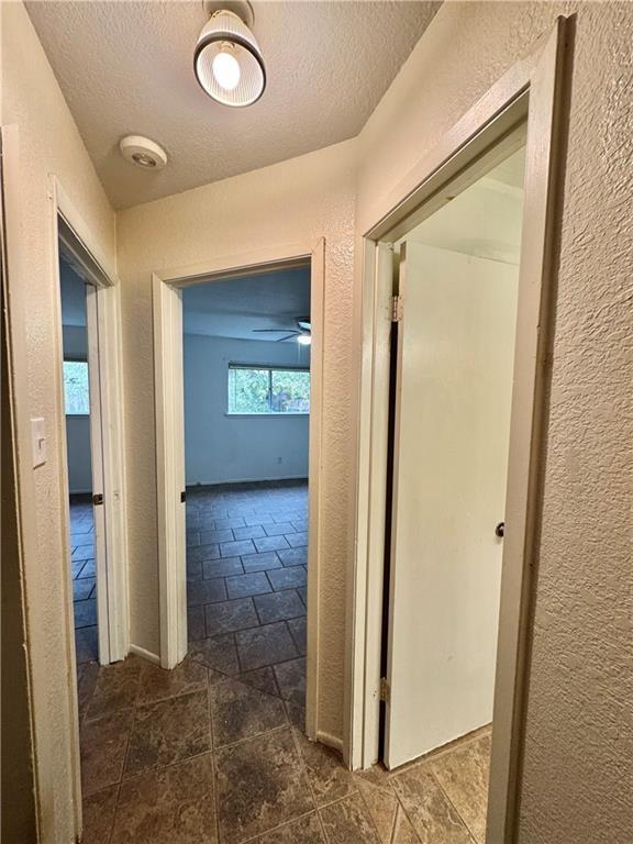 6624 Hardwick Dr, Corpus Christi, TX 78412 - hallway featuring a textured ceiling and a textured wall
