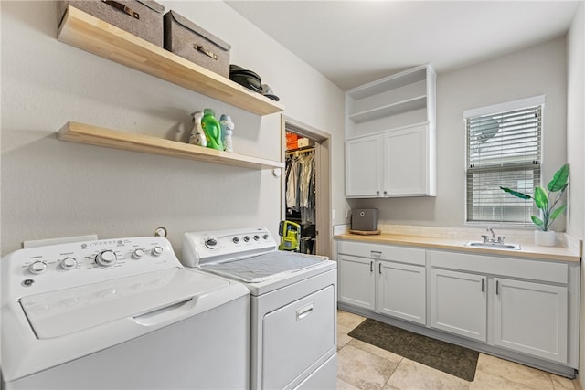 8130 Resplandor St, Corpus Christi, TX 78414 - laundry room with washing machine and clothes dryer, cabinet space, and light tile patterned floors