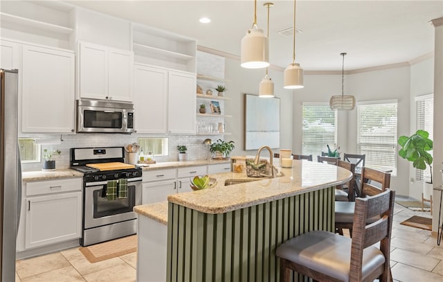 8130 Resplandor St, Corpus Christi, TX 78414 - kitchen with appliances with stainless steel finishes, open shelves, a sink, tasteful backsplash, and a breakfast bar
