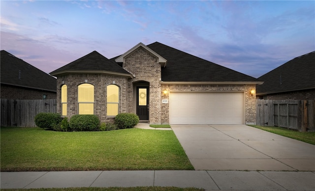 8130 Resplandor St, Corpus Christi, TX 78414 - french provincial home featuring brick siding, an attached garage, concrete driveway, and roof with shingles