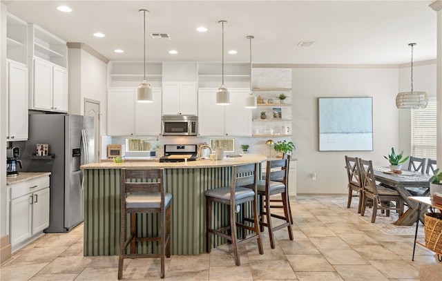 8130 Resplandor St, Corpus Christi, TX 78414 - kitchen featuring appliances with stainless steel finishes, open shelves, backsplash, white cabinets, and crown molding