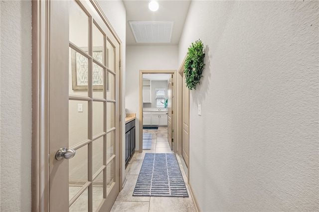 8130 Resplandor St, Corpus Christi, TX 78414 - hallway with light tile patterned floors and a textured wall