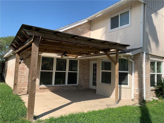 5202 Wentworth Dr, Corpus Christi, TX 78413 - back of house featuring a ceiling fan, a patio area, and brick siding