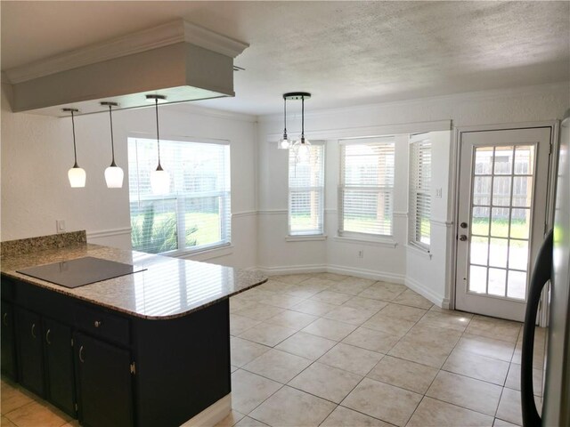 5202 Wentworth Dr, Corpus Christi, TX 78413 - kitchen with dark cabinetry, black electric stovetop, crown molding, and light tile patterned floors