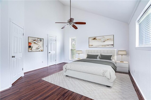 5202 Wentworth Dr, Corpus Christi, TX 78413 - bedroom with wood finished floors, multiple windows, high vaulted ceiling, and ceiling fan