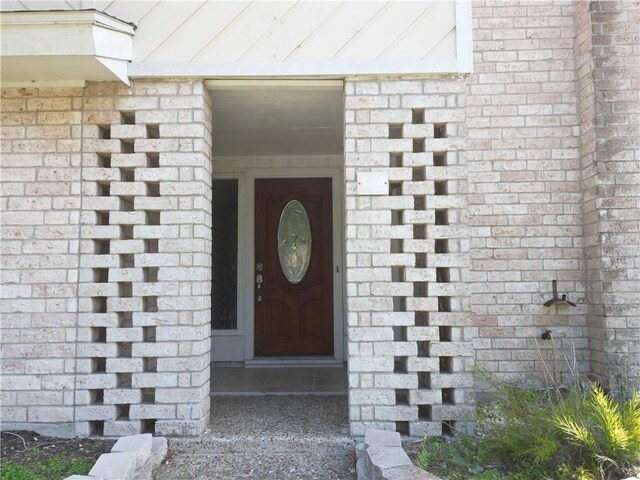 5202 Wentworth Dr, Corpus Christi, TX 78413 - doorway to property with a standing seam roof, brick siding, and a metal roof