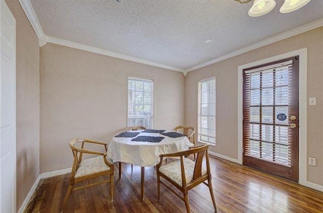 dining room featuring hardwood / wood-style floors, ornamental molding, and a textured ceiling