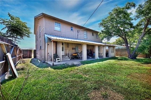 back of property with a patio area and a lawn