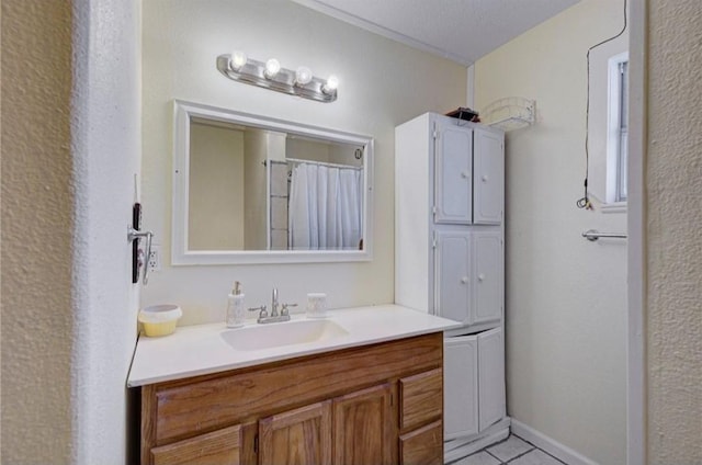 bathroom featuring a textured ceiling, vanity, and tile patterned floors