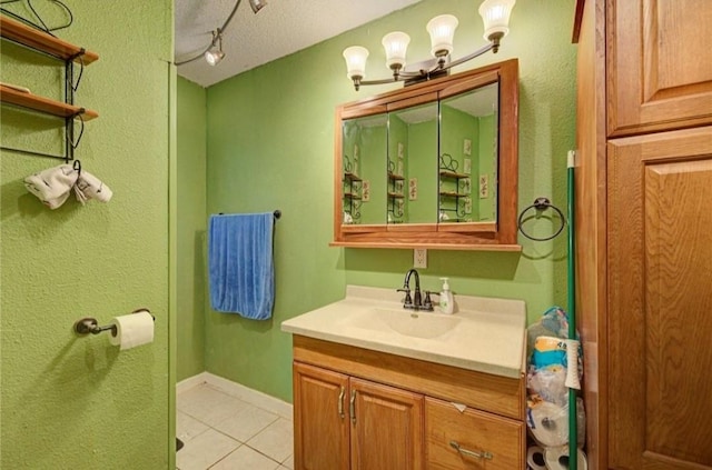 bathroom featuring tile patterned flooring, vanity, and a textured ceiling