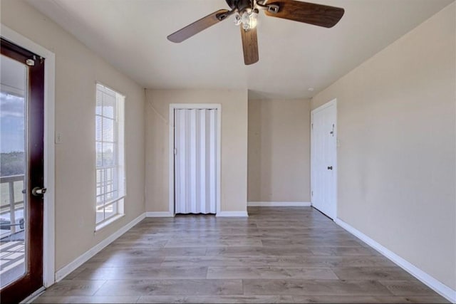 empty room with light hardwood / wood-style flooring and ceiling fan