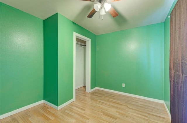 unfurnished bedroom featuring ceiling fan, light wood-type flooring, and a closet