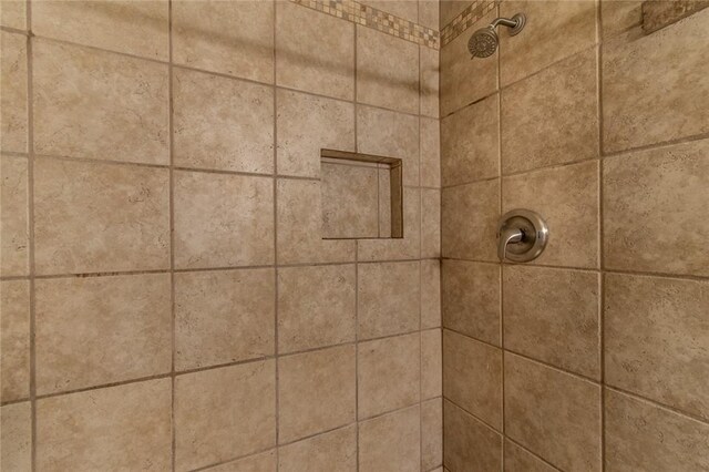 interior details with a tile shower