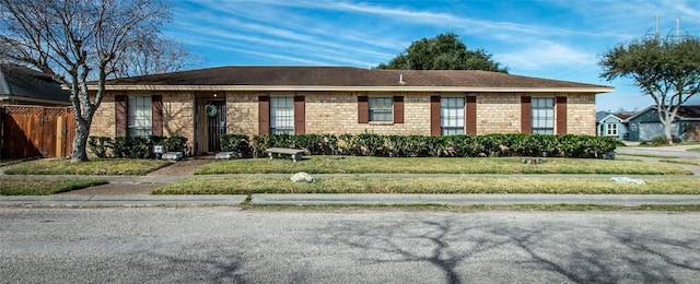 ranch-style home with a front lawn