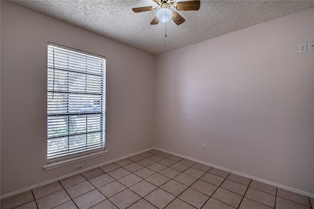 unfurnished room featuring ceiling fan, a textured ceiling, and light tile patterned flooring