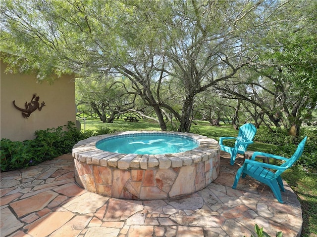 view of pool with a patio area and an in ground hot tub