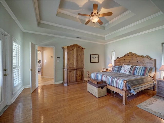 bedroom with ceiling fan, crown molding, and light hardwood / wood-style floors