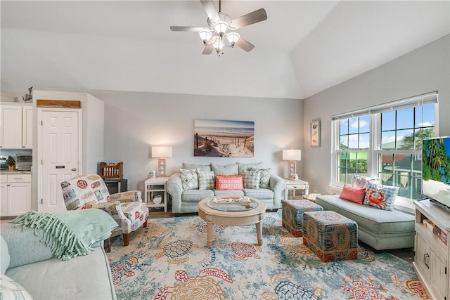 living area featuring a ceiling fan and lofted ceiling