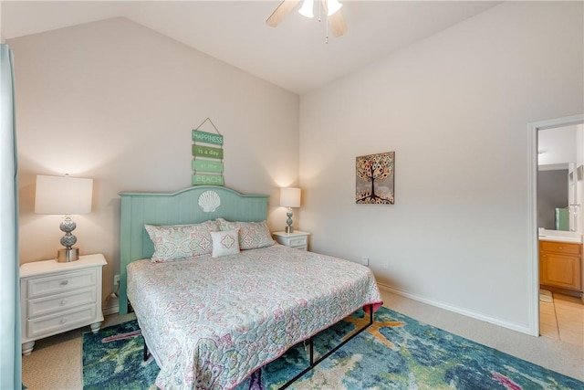 bedroom with carpet floors, baseboards, ensuite bathroom, a ceiling fan, and vaulted ceiling
