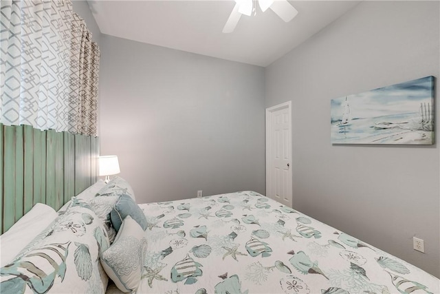 bedroom with a ceiling fan and vaulted ceiling