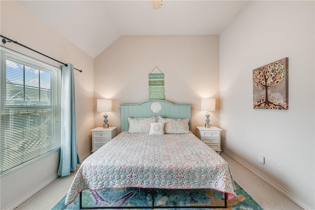 bedroom featuring baseboards, carpet flooring, and lofted ceiling