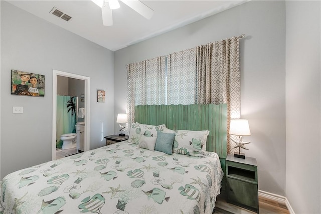 bedroom with visible vents, wood finished floors, baseboards, connected bathroom, and a ceiling fan