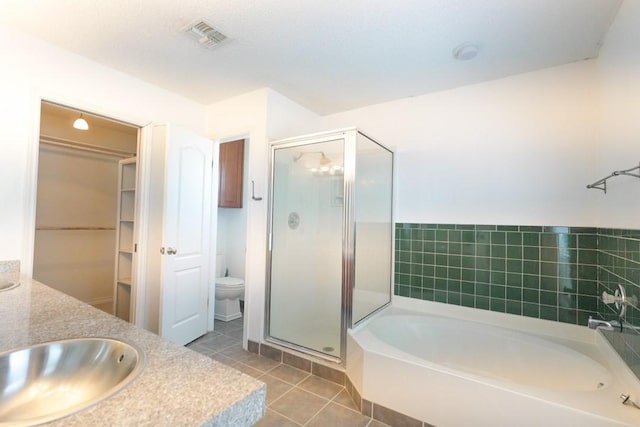 321 Long Pointe Dr, Portland, TX 78374 - bathroom featuring a garden tub, a stall shower, tile patterned floors, double vanity, and a spacious closet