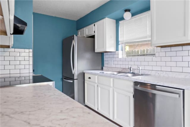 2809 Vancouver Dr, Corpus Christi, TX 78414 - kitchen with appliances with stainless steel finishes, a sink, white cabinets, and tasteful backsplash