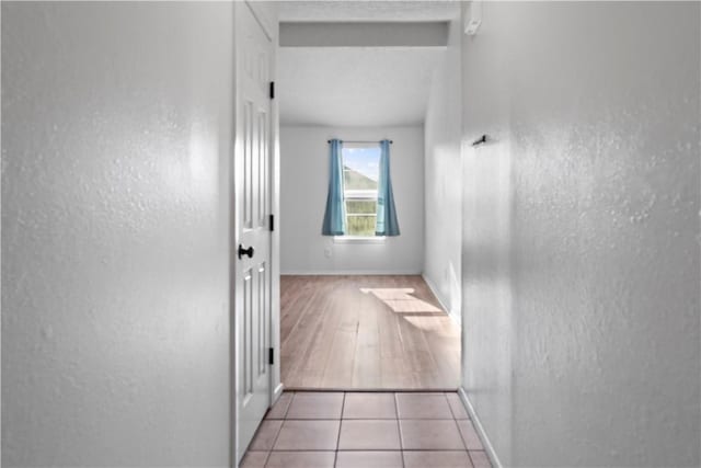 2809 Vancouver Dr, Corpus Christi, TX 78414 - hallway featuring a textured wall, baseboards, and tile patterned flooring