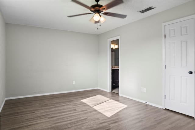 2809 Vancouver Dr, Corpus Christi, TX 78414 - unfurnished bedroom with wood finished floors, baseboards, connected bathroom, and ceiling fan