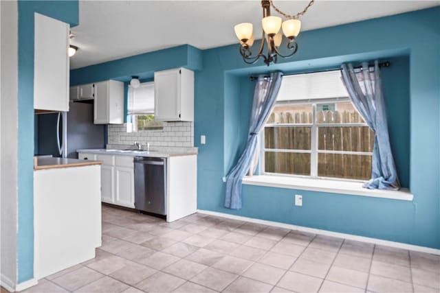 2809 Vancouver Dr, Corpus Christi, TX 78414 - kitchen featuring dishwasher, white cabinets, a chandelier, and light tile patterned flooring