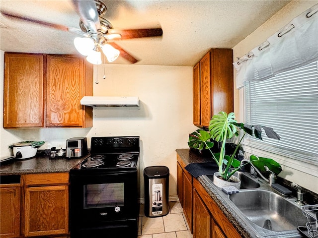 kitchen featuring a textured ceiling, black / electric stove, light tile patterned floors, ceiling fan, and sink