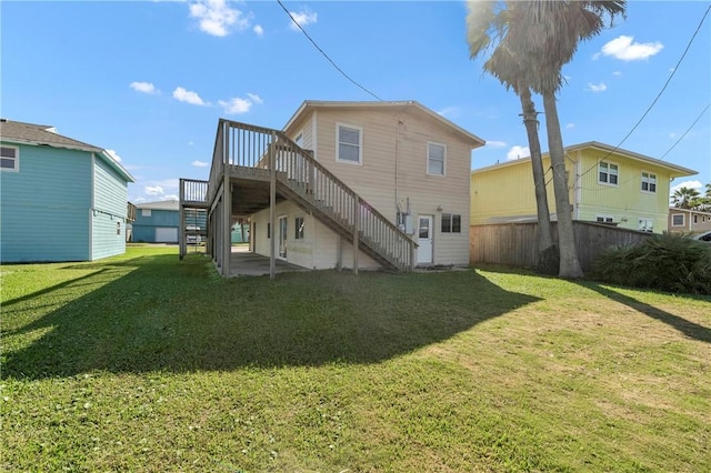 rear view of property with a wooden deck and a yard