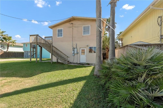 back of house with a lawn and a wooden deck