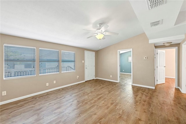 empty room with vaulted ceiling, light hardwood / wood-style flooring, and ceiling fan