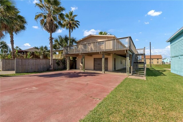 rear view of house with a lawn and a deck