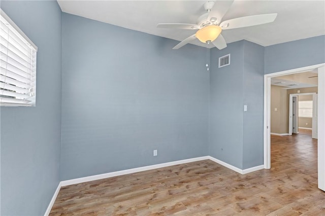 empty room featuring ceiling fan and light wood-type flooring