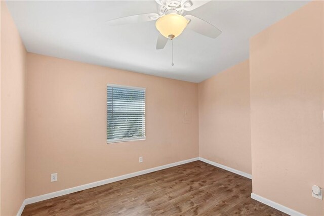 unfurnished room with ceiling fan and hardwood / wood-style flooring