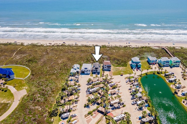 bird's eye view featuring a water view and a beach view