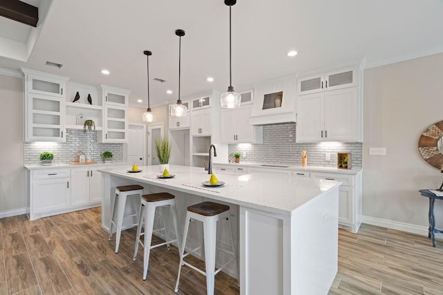 kitchen featuring glass insert cabinets and white cabinets