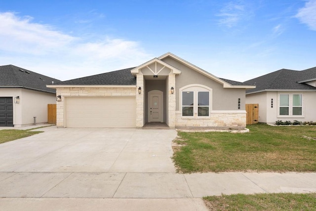 ranch-style home featuring a shingled roof, concrete driveway, an attached garage, a front yard, and fence