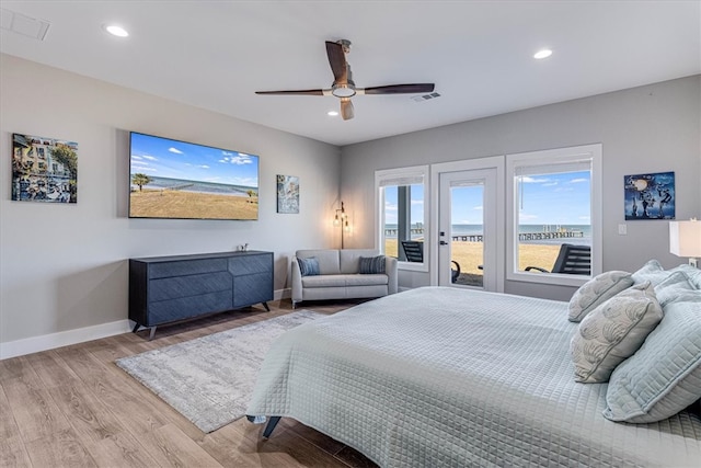 bedroom featuring baseboards, recessed lighting, wood finished floors, and access to exterior