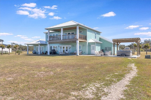 rear view of house with a lawn, a patio, a balcony, french doors, and a pergola