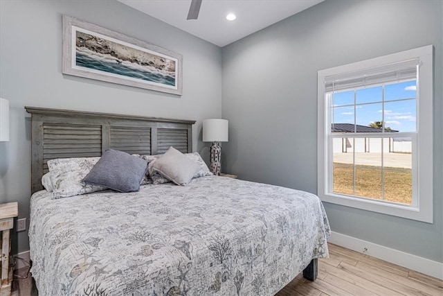 bedroom featuring a ceiling fan, baseboards, wood finished floors, and recessed lighting