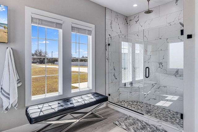 bathroom featuring a marble finish shower