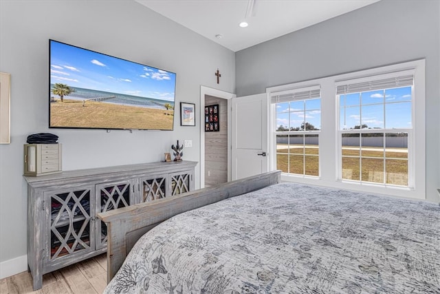 bedroom with recessed lighting, wood finished floors, and baseboards