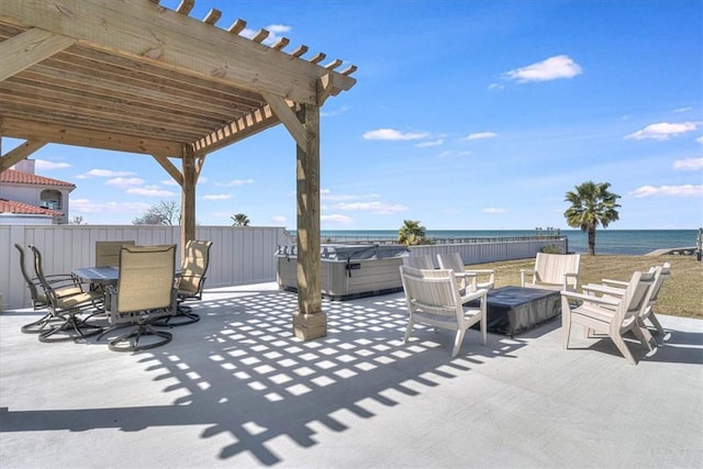 view of patio with a water view, a hot tub, a pergola, and outdoor dining space