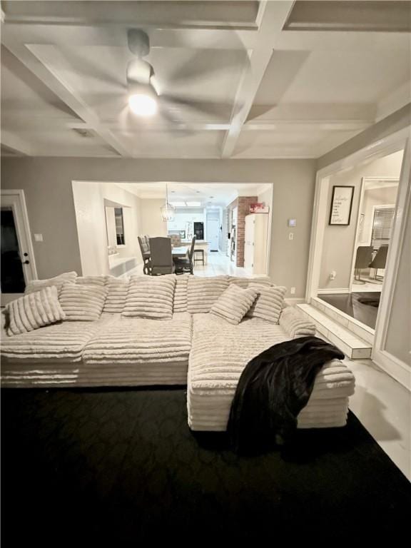 bedroom with coffered ceiling, connected bathroom, a ceiling fan, refrigerator, and beam ceiling